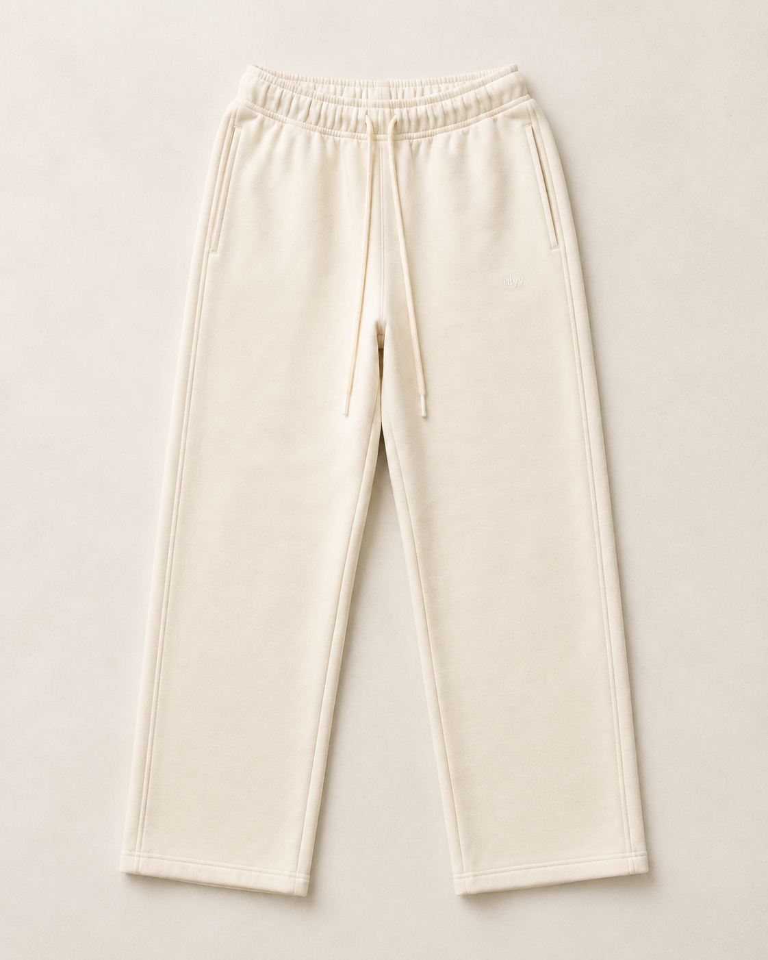 Cream ULYV Essential Sweatpants alone, full product studio view