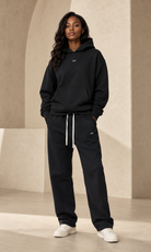 Female adult model wearing the ULYV black Essential matching set
