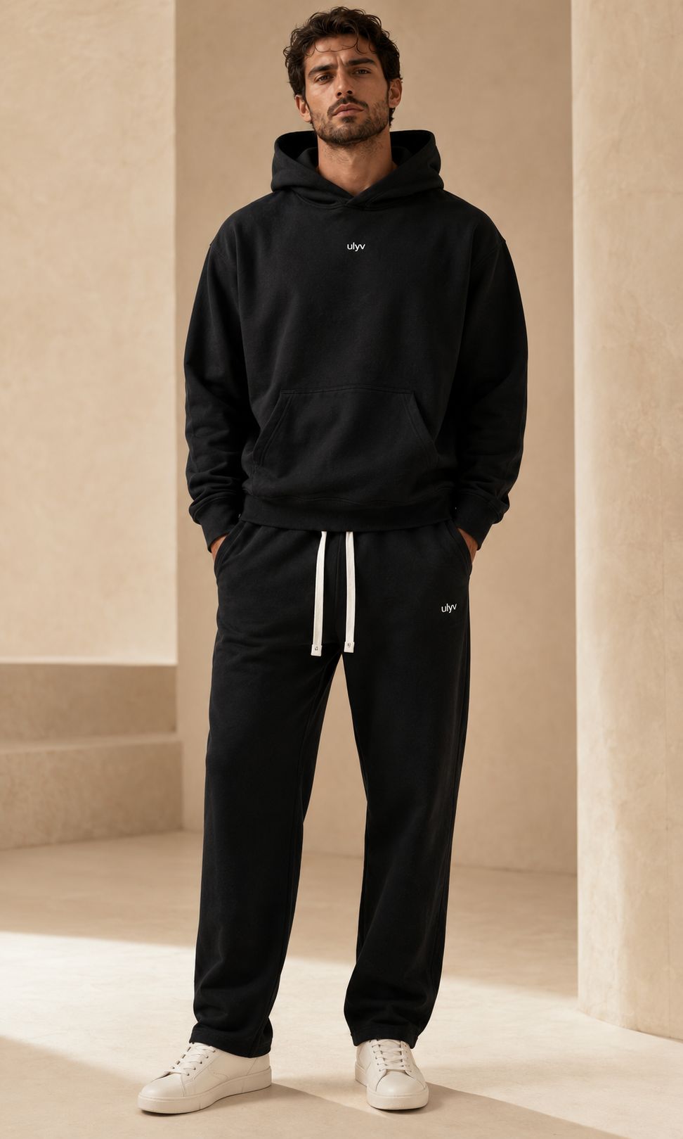 Male adult model wearing the ULYV black Essential matching set