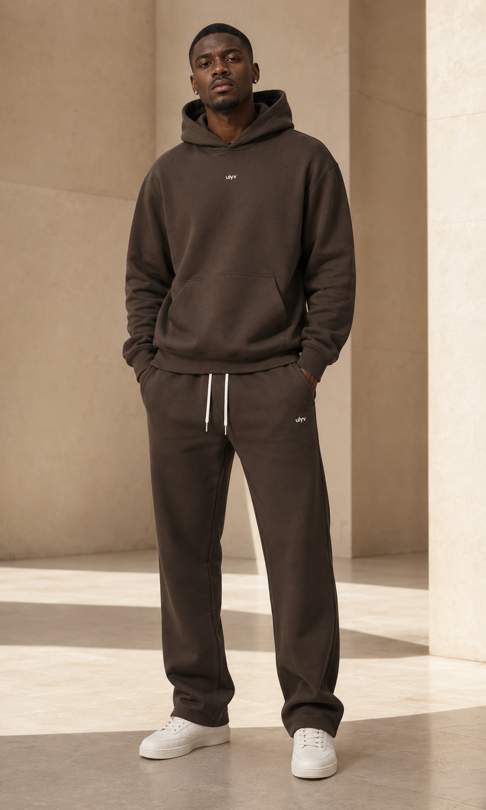 Male adult model wearing the ULYV brown Essential matching set