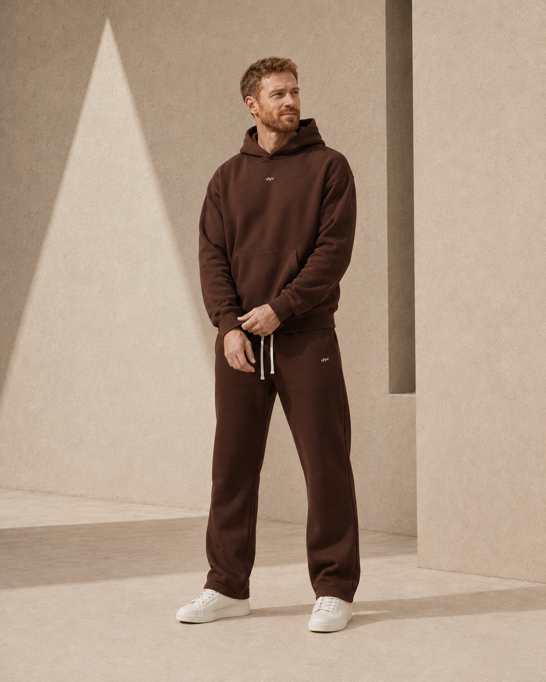 Brown ULYV matching hoodie and sweatpants on an adult male model, full length view