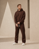 Brown ULYV matching hoodie and sweatpants on an adult male model, full length view