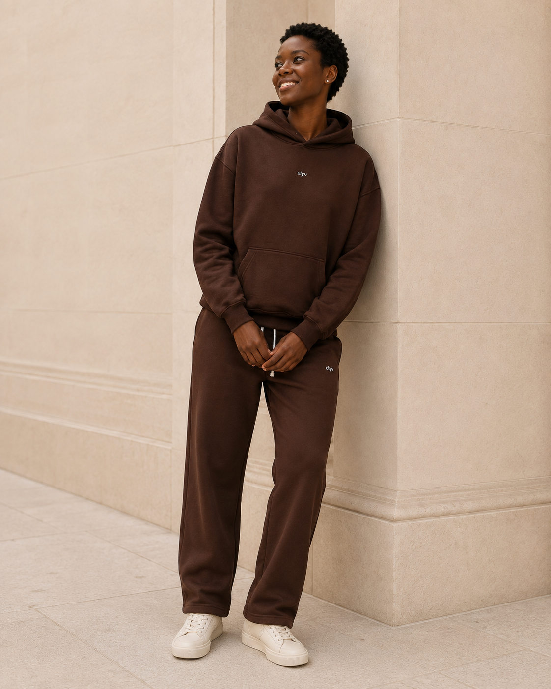 Adult model in the ULYV Brown matching hoodie and sweatpants, full length view