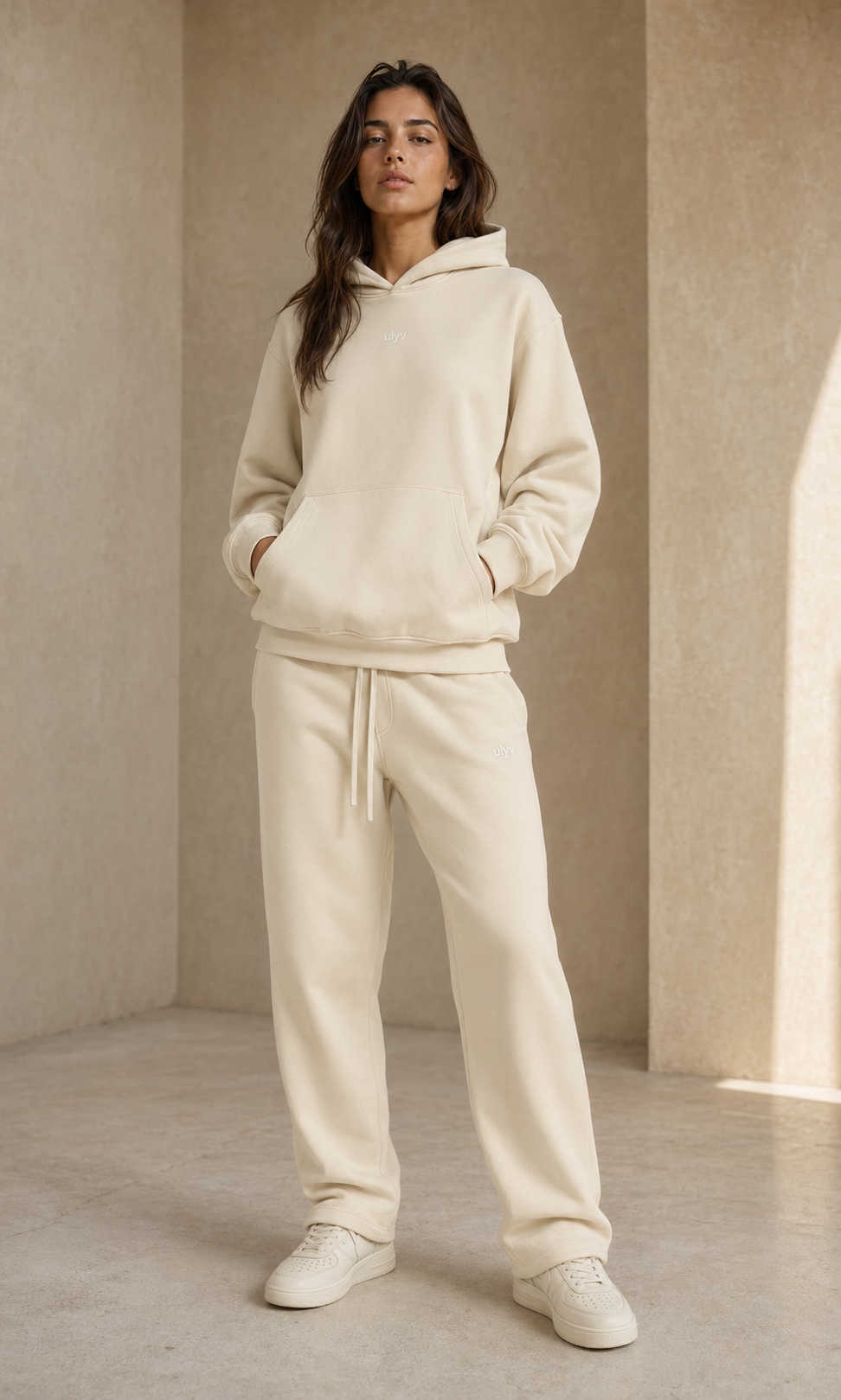 Female adult model wearing the ULYV cream Essential matching set
