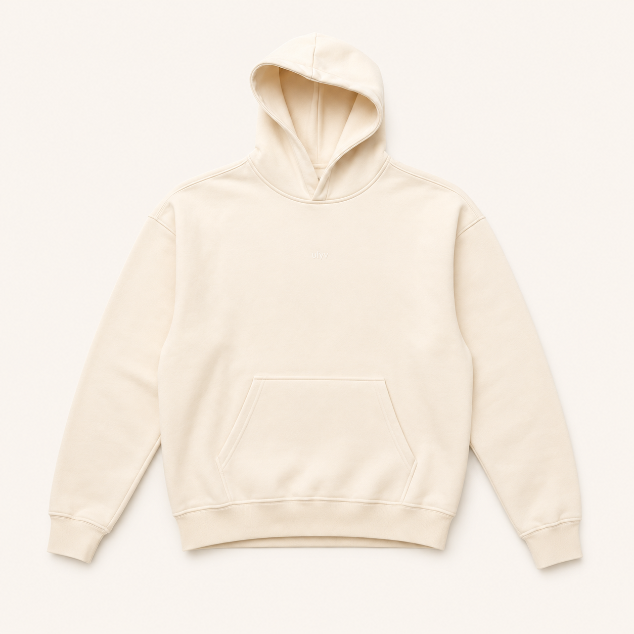 ULYV cream Essential Hoodie studio view
