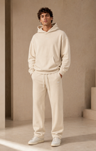 Male adult model wearing the ULYV cream Essential matching set