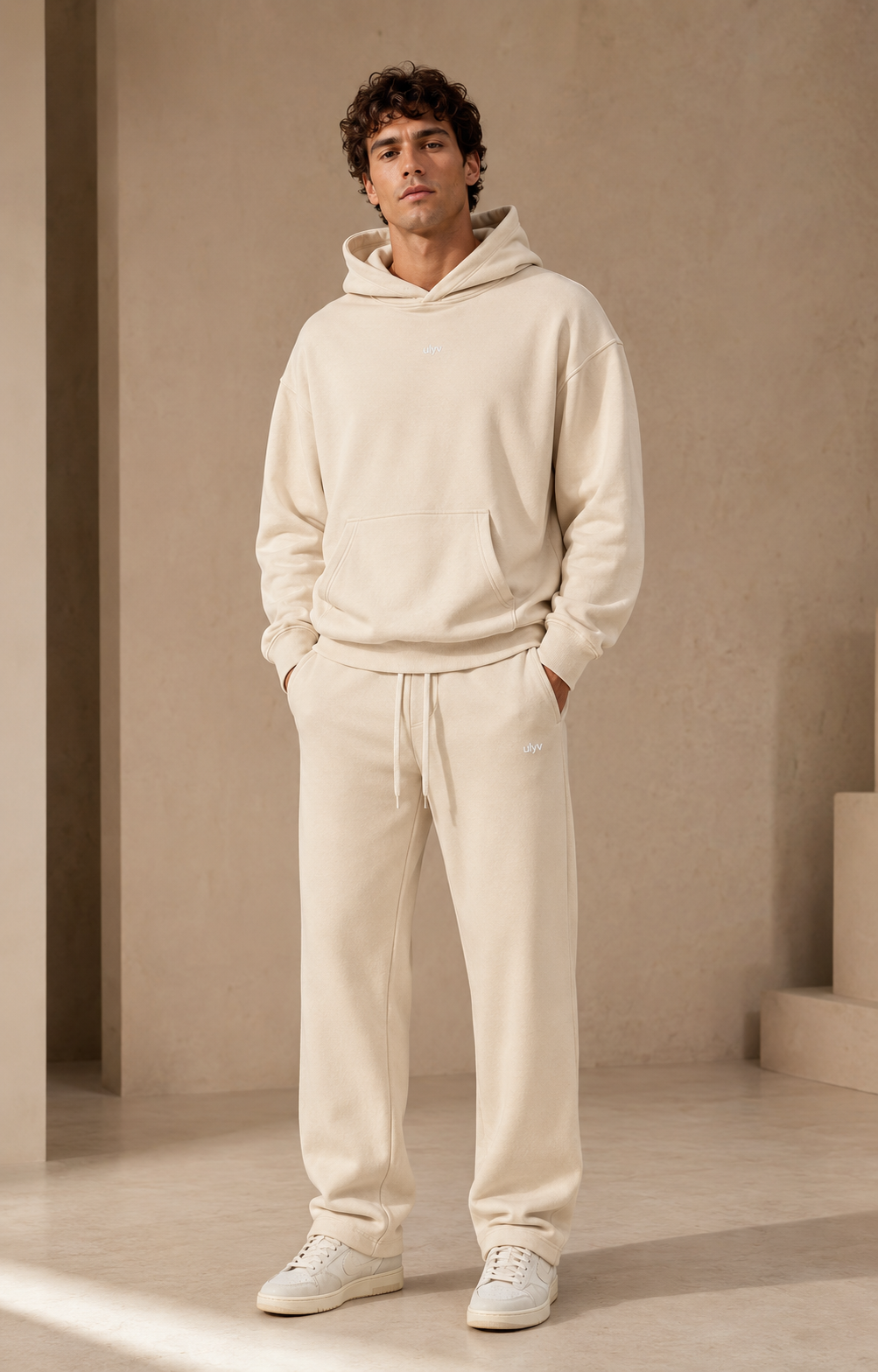 Male adult model wearing the ULYV cream Essential matching set