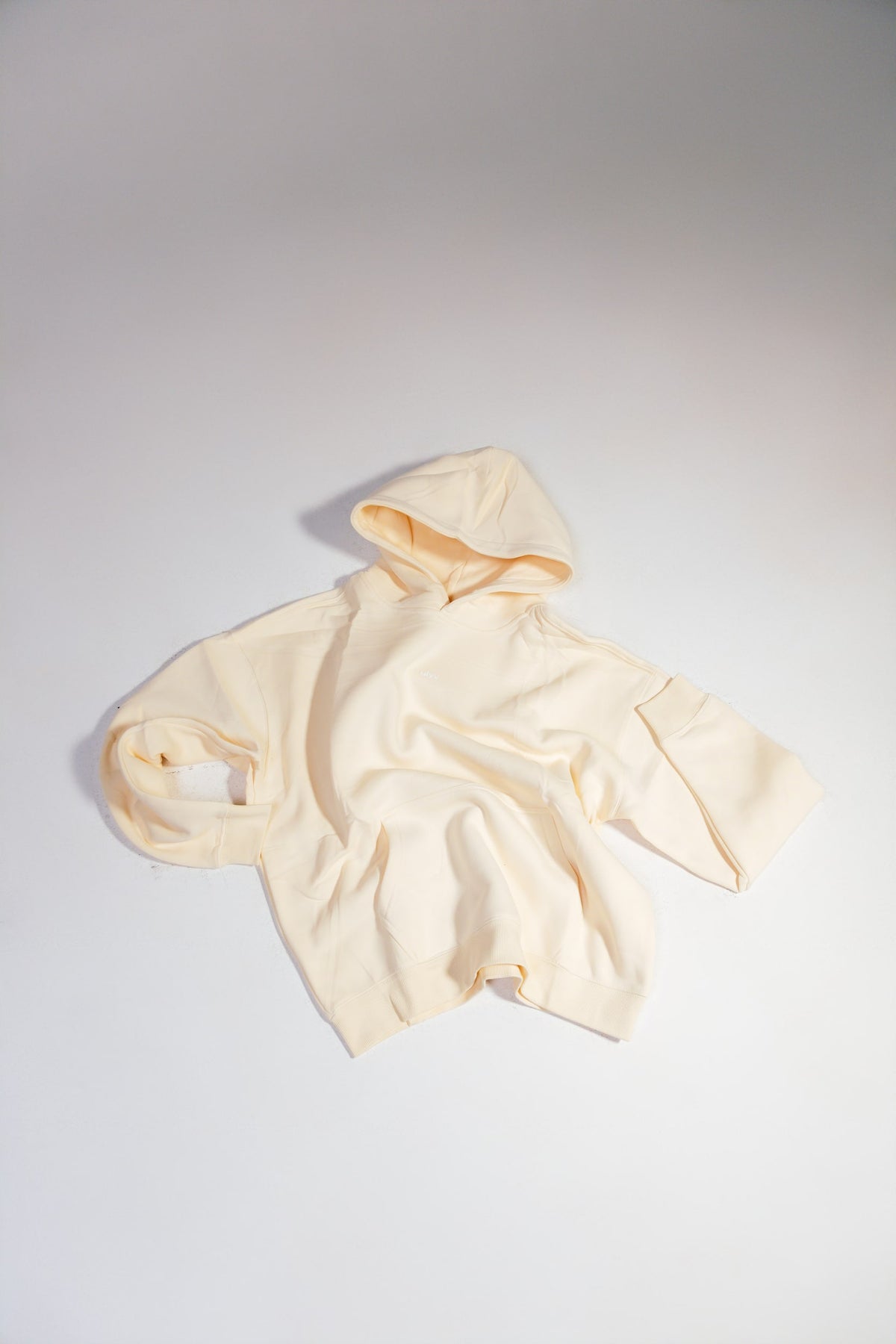 ULYV cream Essential Hoodie flat lay