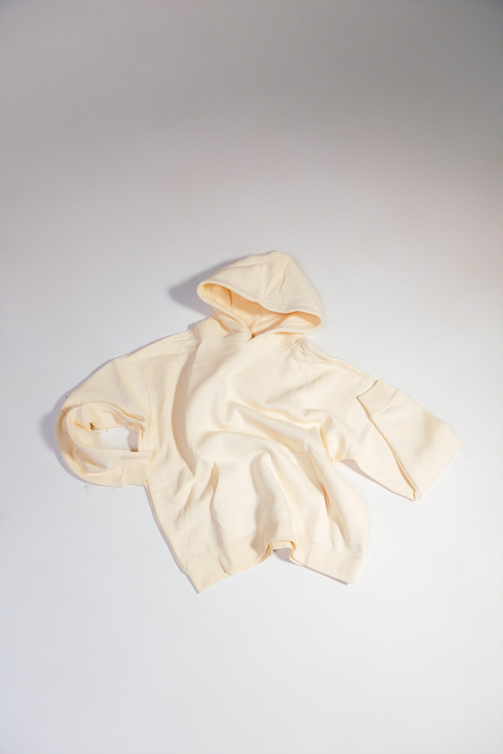 ULYV cream essential hoodie flat lay