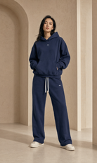 Female adult model wearing the ULYV navy Essential matching set