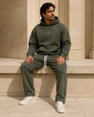 Adult model in the ULYV Olive matching hoodie and sweatpants, full length view