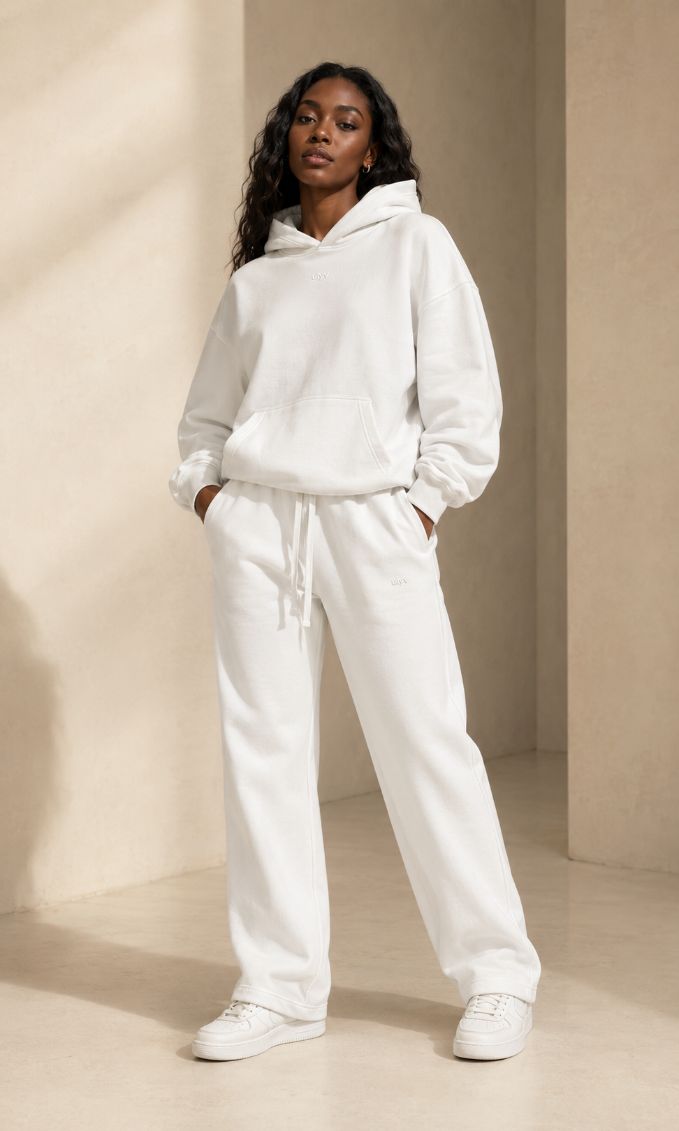 Female adult model wearing the ULYV white Essential matching set