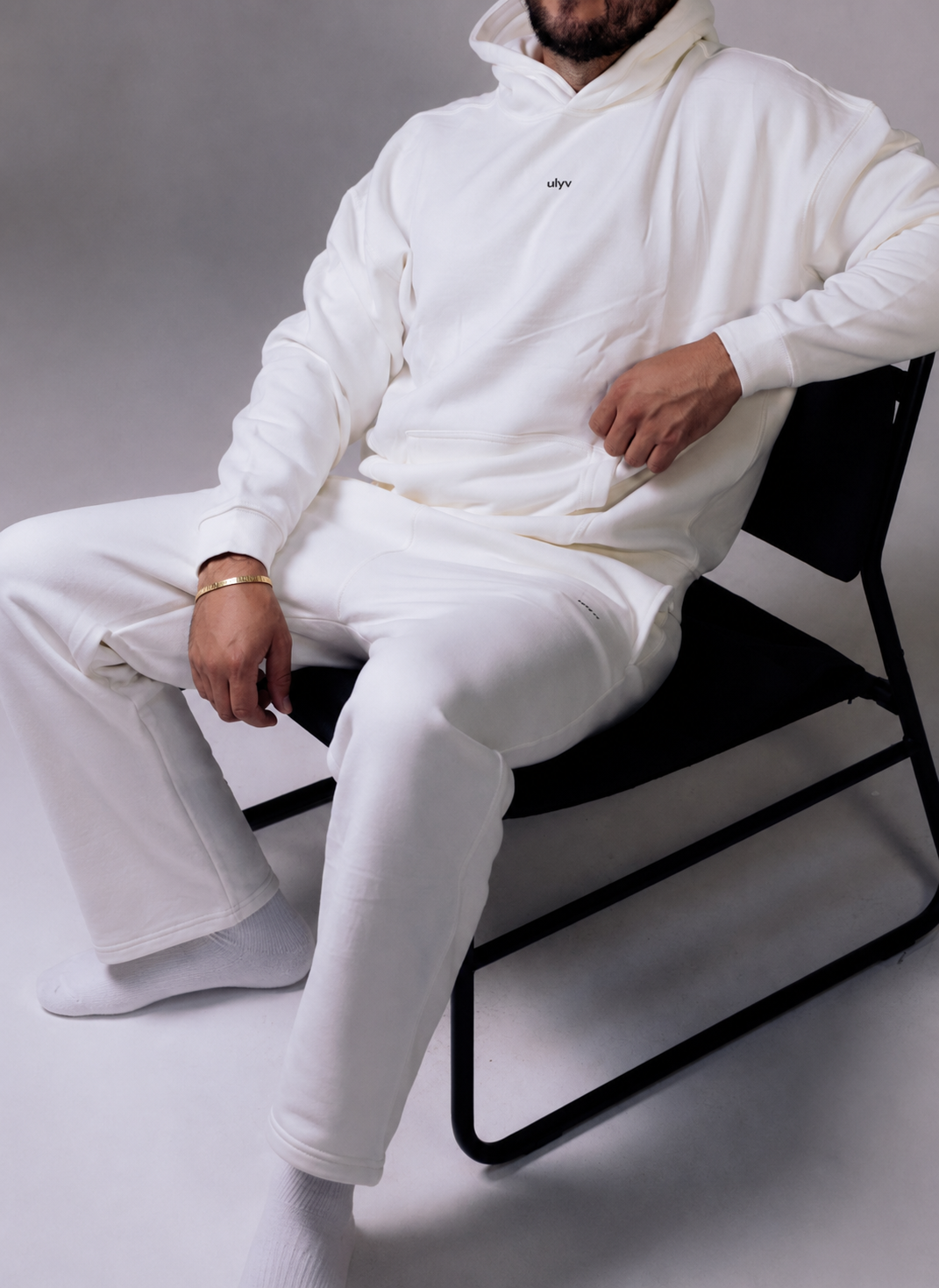 Model seated in the white ULYV Essential set